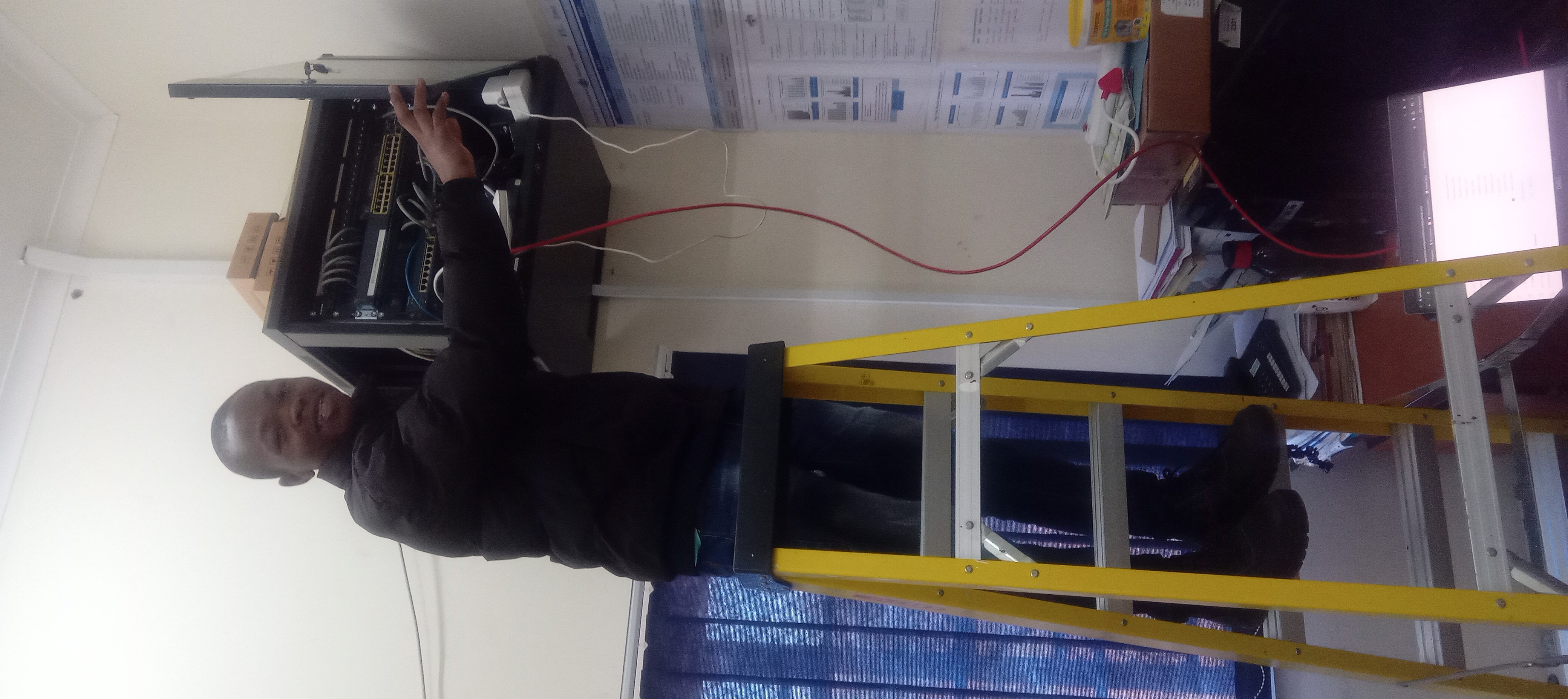 Mabona working on network rack at HMIS Unit